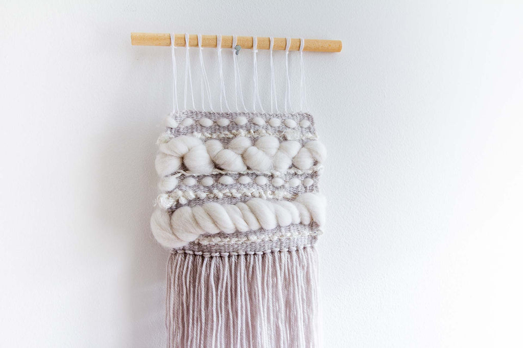 Icicle is a woven wall hanging made up of white and grey yarns.